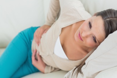 woman holding stomach in pain because of diarrhoea